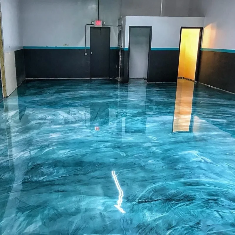 Glossy teal and silver metallic epoxy flooring in a commercial interior.