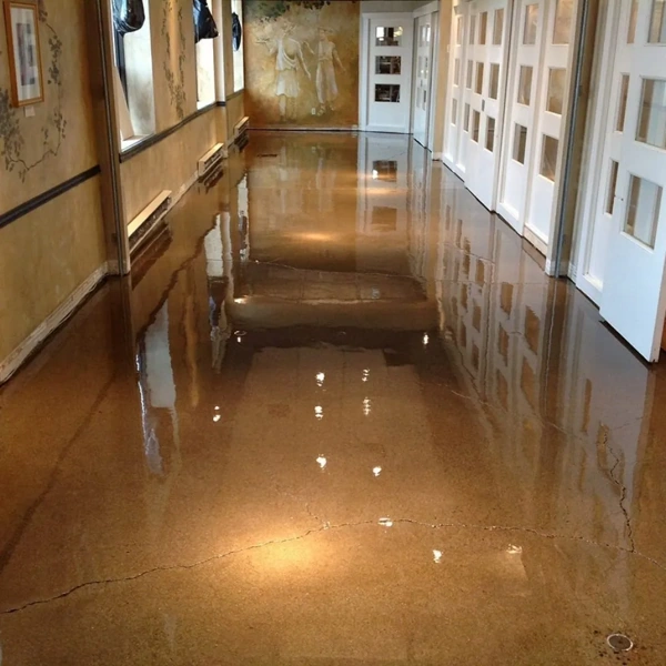 High-gloss polished concrete hallway with warm lighting.