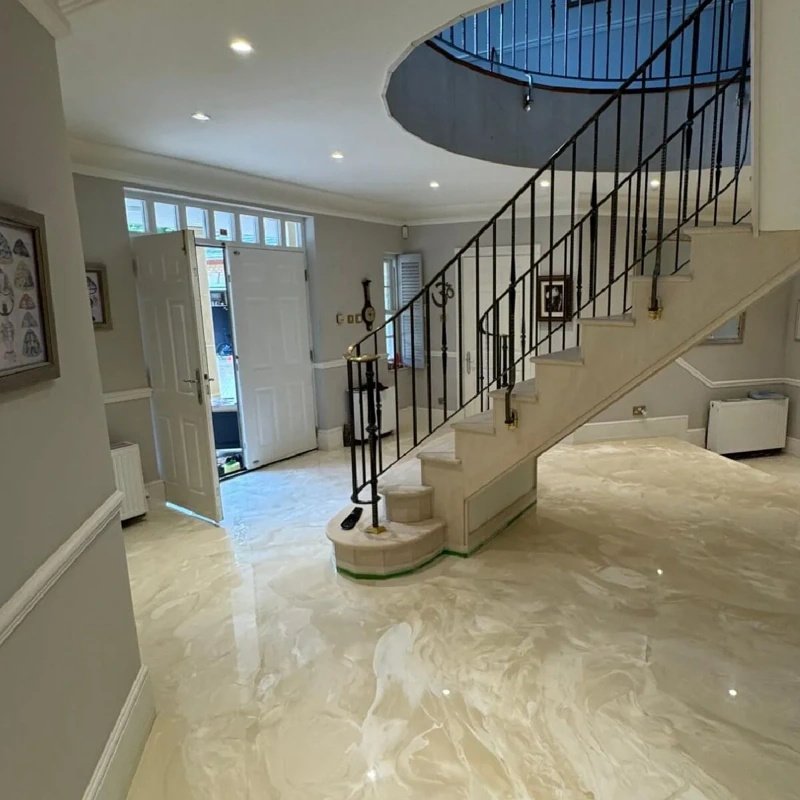 Modern marble foyer with a spiral staircase.