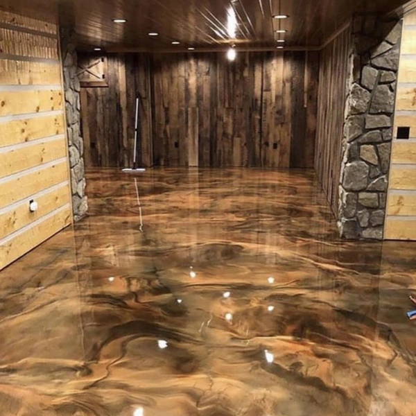 Rustic room with wood walls and metallic epoxy flooring.